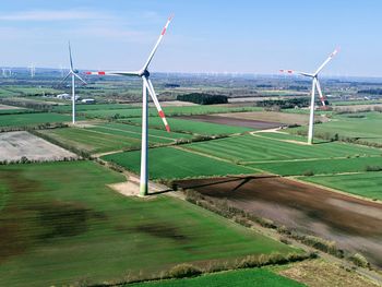 Windmill on field against sky