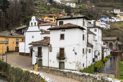 High angle view of houses by river in town