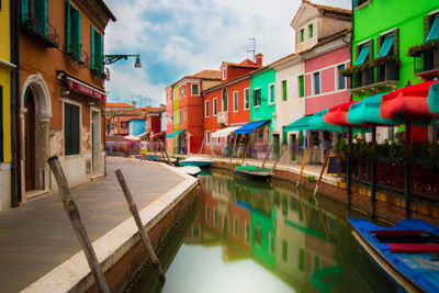 View of canal amidst buildings in city