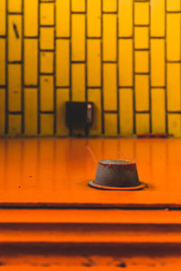 Close-up of empty chair on table against wall