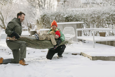 Happy family with christmas tree at winter