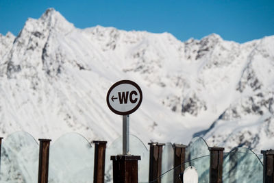 Low angle view of text on snow against sky