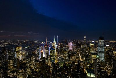 High angle view of illuminated buildings against sky at night