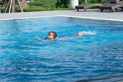 High angle view of woman swimming in pool