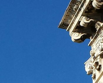 Low angle view of statue against clear blue sky