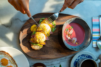 Cropped hand of person eating food at table