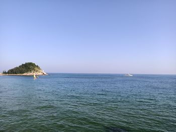 Scenic view of sea against clear blue sky