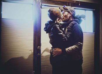 Couple standing by window