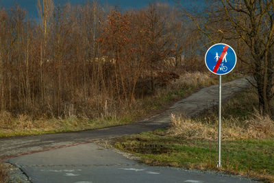 Road sign against sky