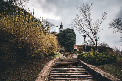 Footpath amidst buildings against sky