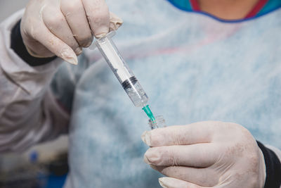 Midsection of person holding mobile phone