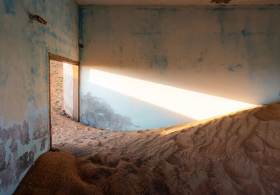 Sand fills a house in the abandoned village of al madam, uae