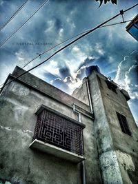 Low angle view of building against cloudy sky