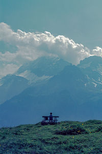 Scenic view of land and mountains against sky