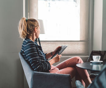 Young woman using laptop at home