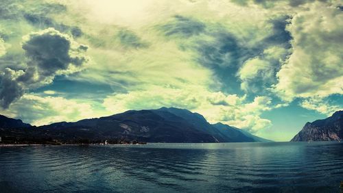 Scenic view of lake against cloudy sky