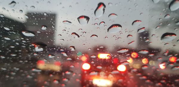 Full frame shot of wet glass window in rainy season