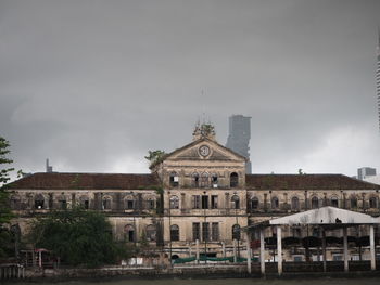 Buildings against cloudy sky