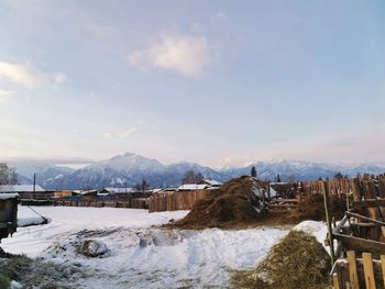 Snow covered landscape against sky