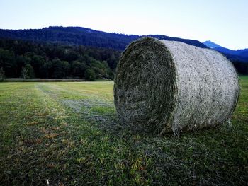 Hay bales on field against sky