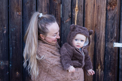 Woman holding baby in her hands. mother and son. kid watching at camera.