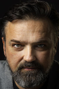 Portrait of a middle aged man on a black background