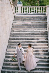 Couple standing on staircase