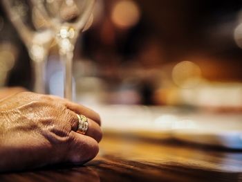 Close-up of man holding hands on table