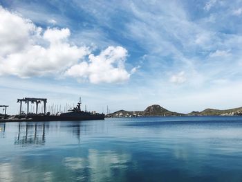 Commercial dock by sea against sky