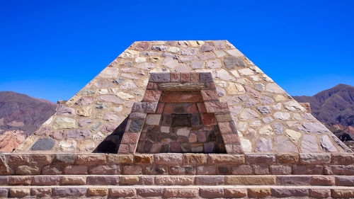 Low angle view of historical building against clear blue sky