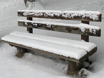 Bench on snow covered land