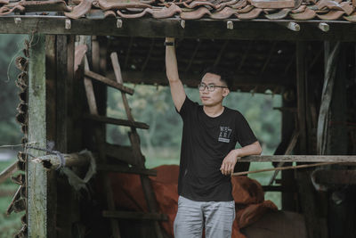 Full length of young man standing in front of built structure