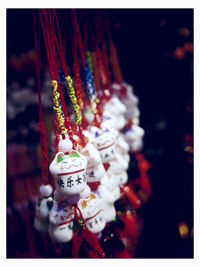 Close-up of trinkets hanging for sale at market stall