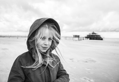 Portrait of girl at beach against sky