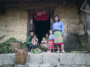 Full length portrait of smiling girl standing outdoors