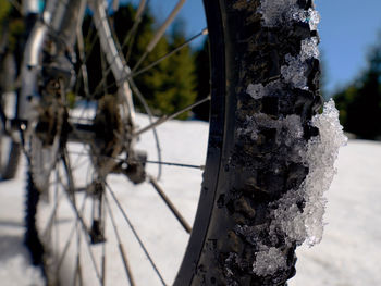 Close-up of bicycle wheel during winter