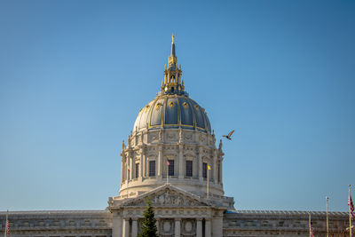 Low angle view of historic building against clear blue sky