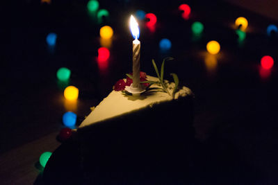 Close-up of illuminated candles on wall