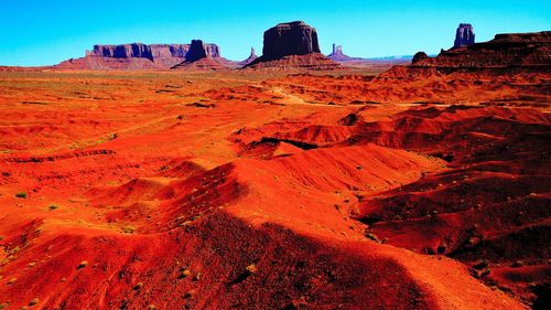 Scenic view of mountains against blue sky