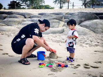 Children playing on sand at beach