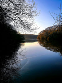 Scenic view of lake against sky at sunset