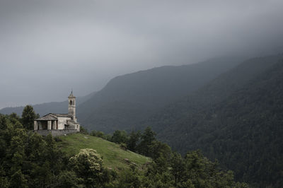 Scenic view of building and mountains against sky