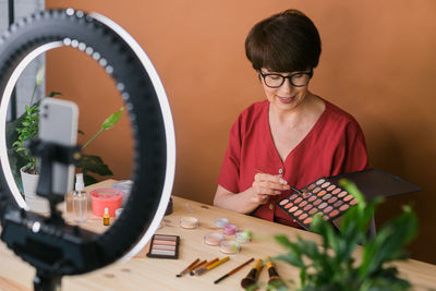 Make up artist vlogging in front of ring light at home