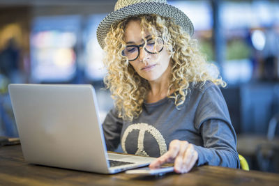 Young woman using laptop at table