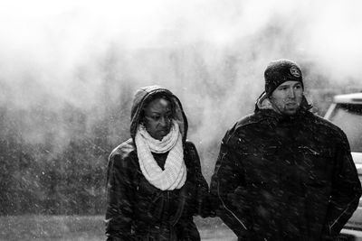 Young couple on snow during rainy season