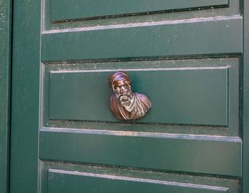 Italian door handle, on a green door in venise.