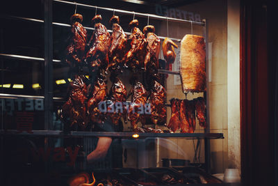 Storefront view of hanging ducks in a restsurant. 