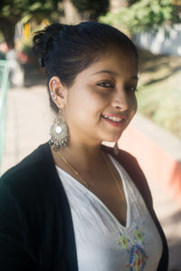 Portrait of a smiling young woman looking away