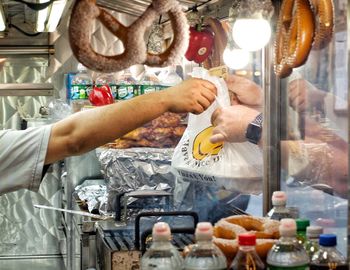 Midsection of man preparing food in store