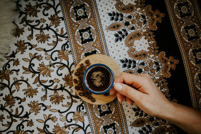 Midsection of woman holding coffee cup